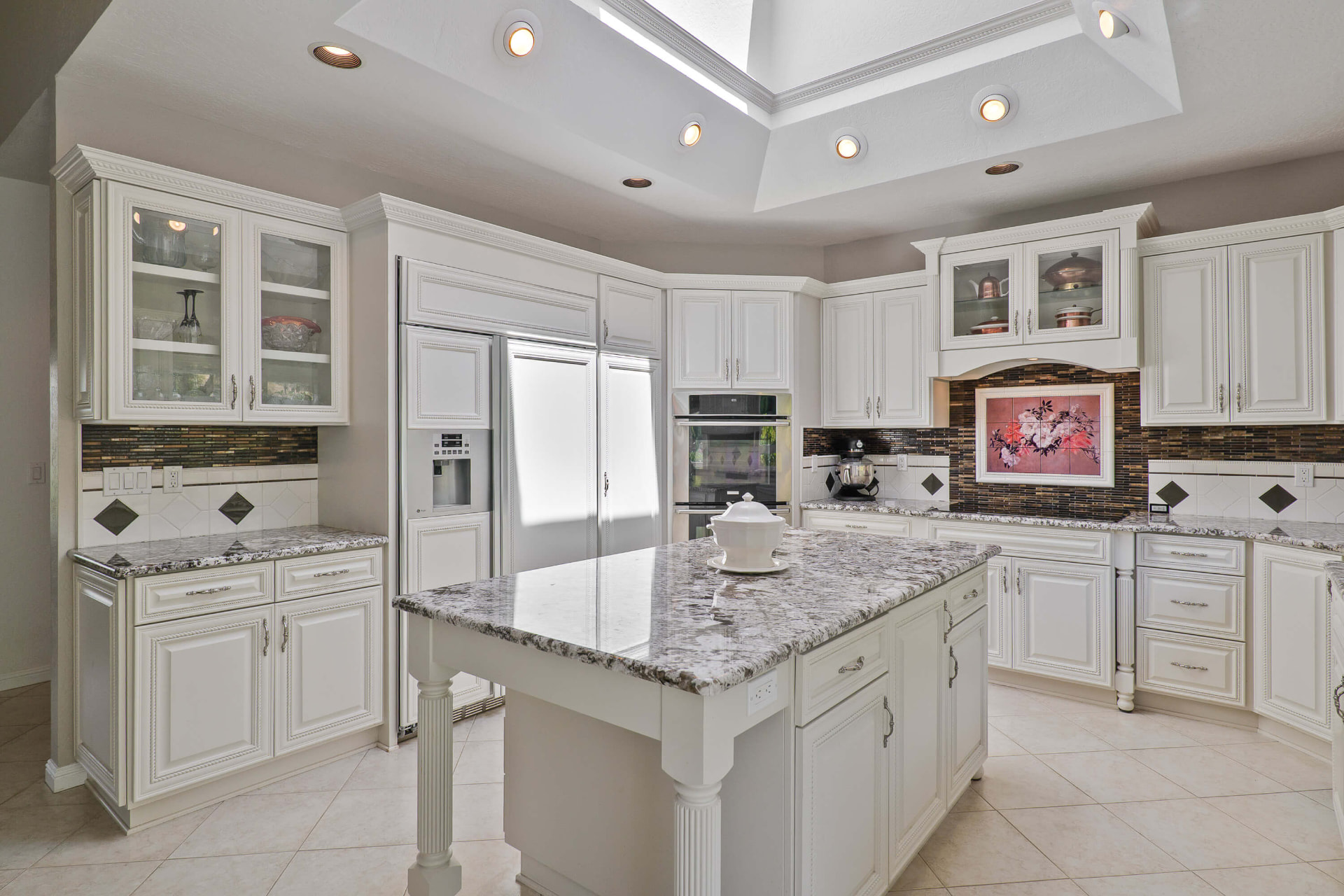 Kitchen with granite island and double wall ovens